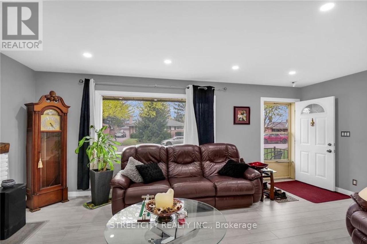 A living room with a brown leather couch and a wooden grandfather clock.