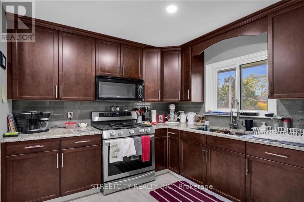 A kitchen with brown cabinets and a black stove top oven.