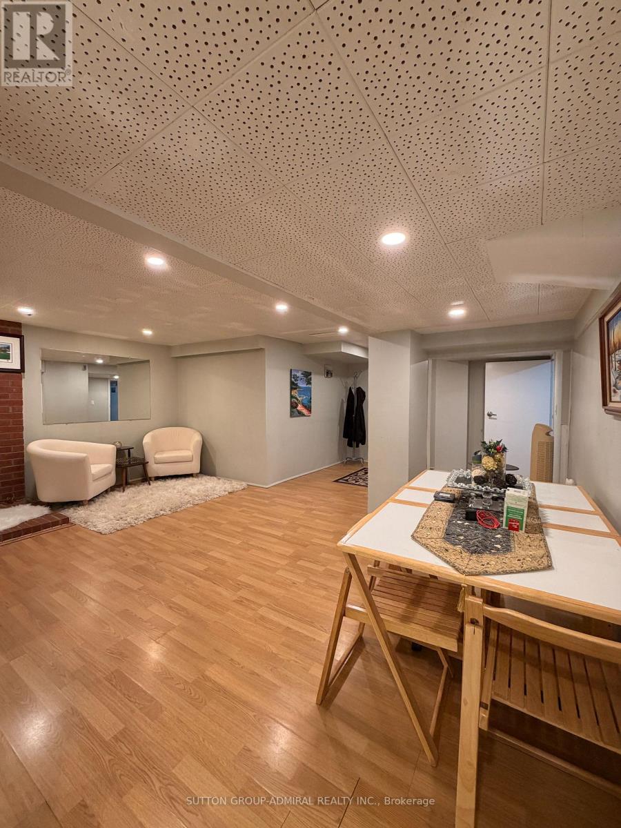 A dining room with a wooden table and chairs.