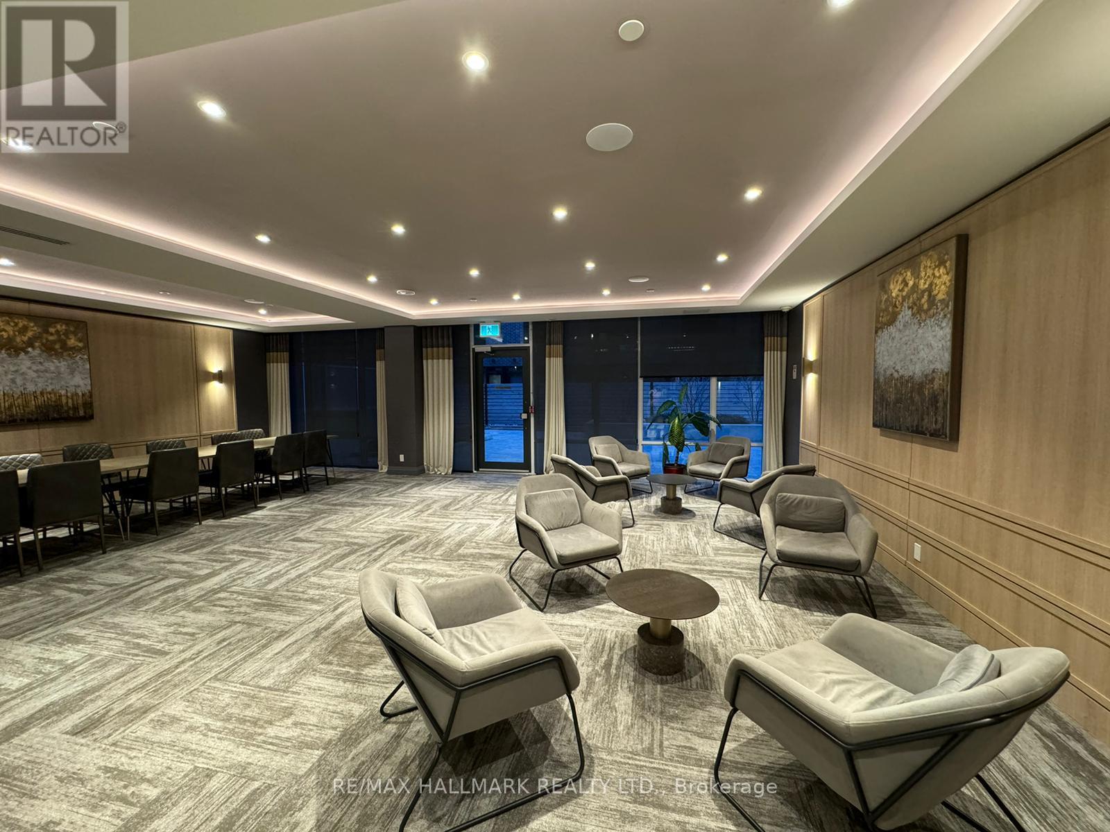 A spacious waiting area with comfortable seating and a carpeted floor.