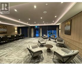 A spacious waiting area with comfortable seating and a carpeted floor.