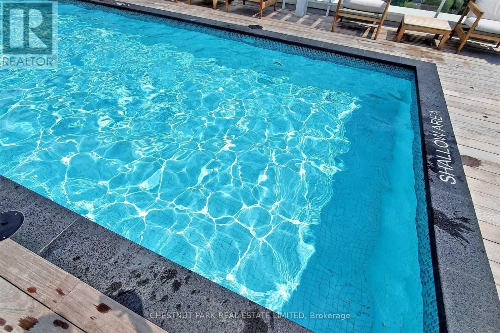 A pool with a blue tinted water.