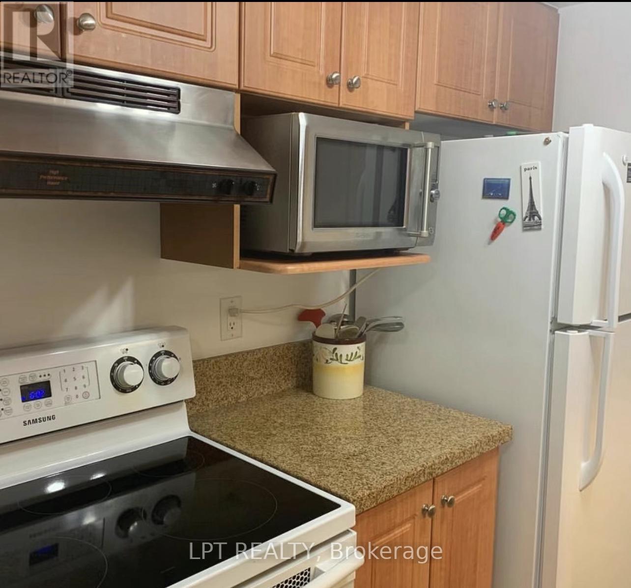 A kitchen with a stove, microwave, and refrigerator.
