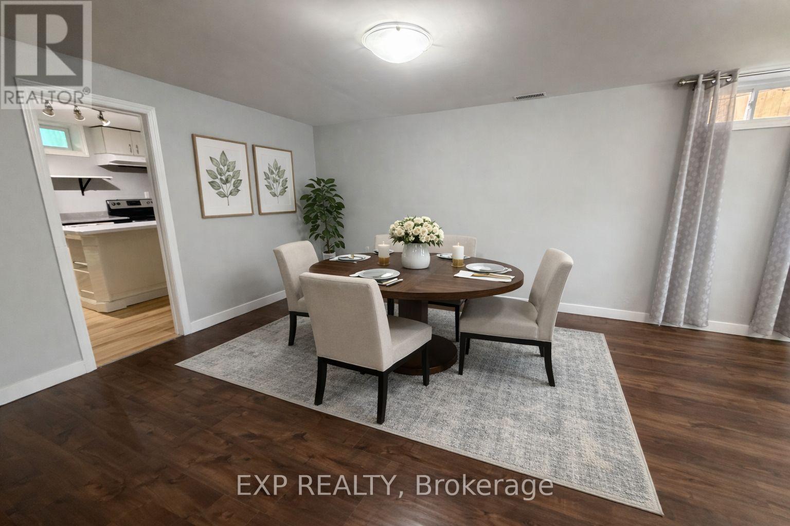 A dining room with a table set for four.