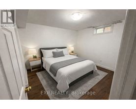 A bedroom with a bed, nightstands, and a rug.