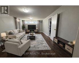 A living room with a grey sofa, a coffee table, and a television.
