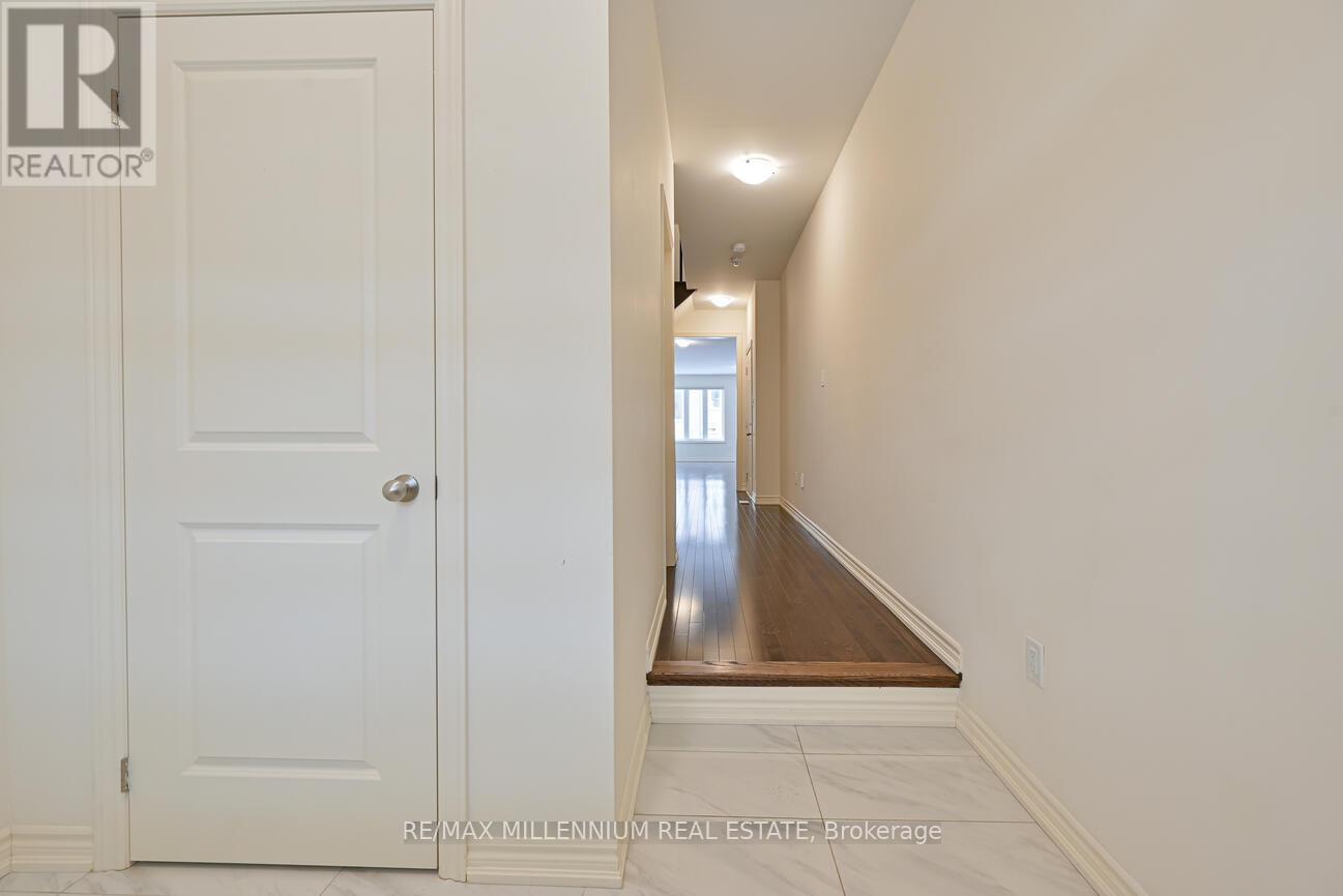 A hallway with a white door and a light on the ceiling.