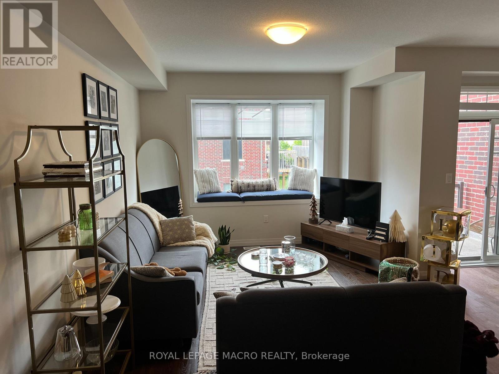 A living room with a grey couch and a black coffee table.
