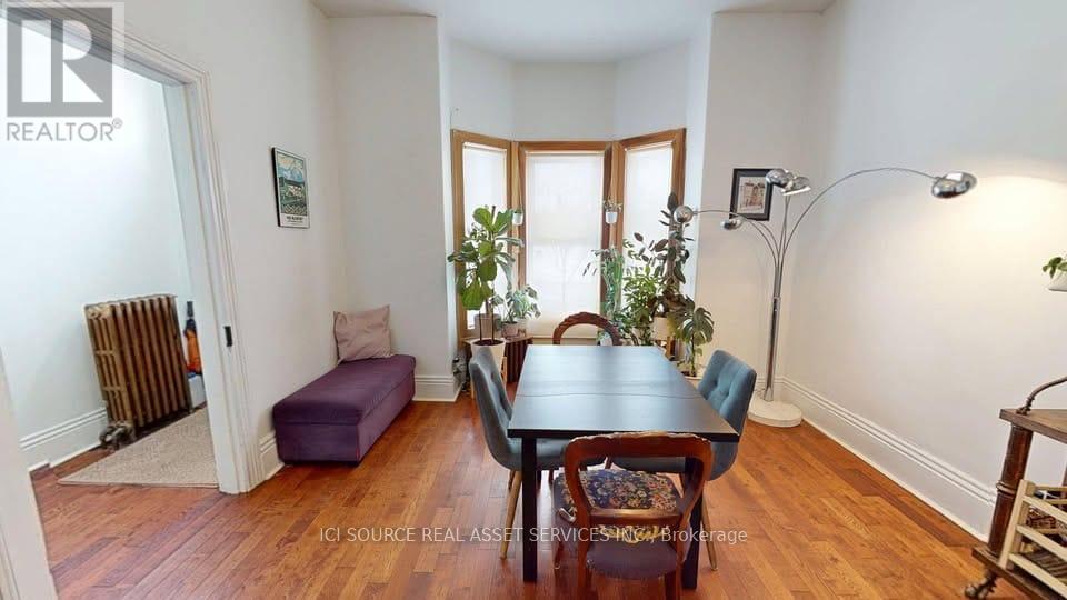 A dining room with a table and chairs.