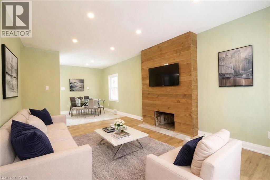 A living room with a fireplace and a flat screen TV.