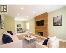 A living room with a fireplace and a flat screen TV.