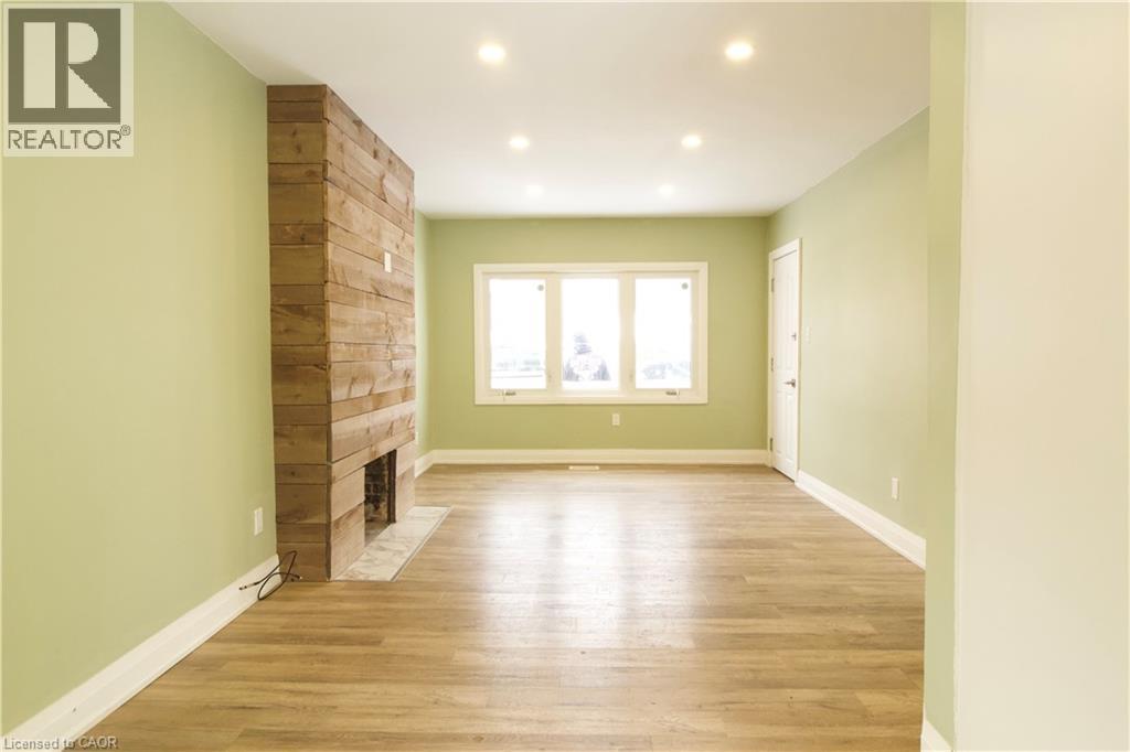 A room with a wooden wall and a fireplace.
