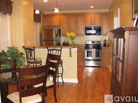 A kitchen with wooden floors and furniture.