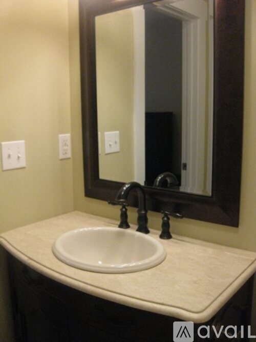 A bathroom sink with a large mirror above it.