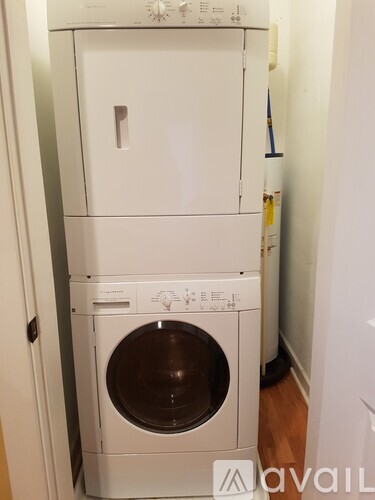 A white washing machine and dryer stacked on top of each other.