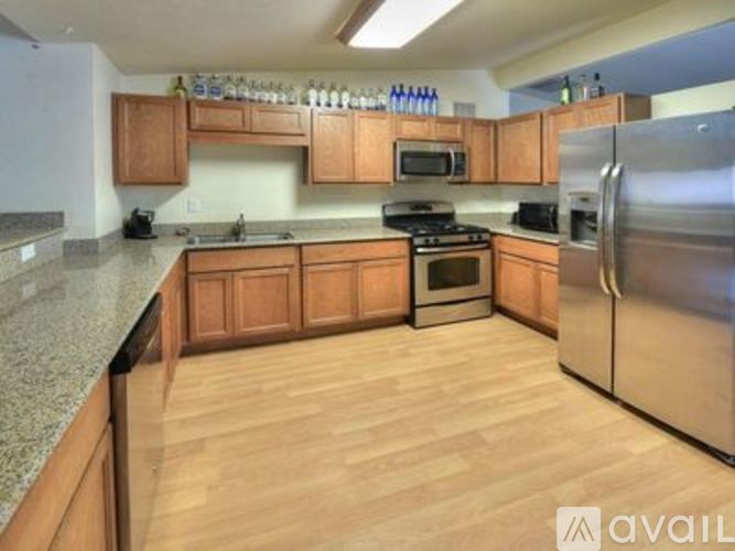 A kitchen with wooden cabinets and stainless steel appliances.