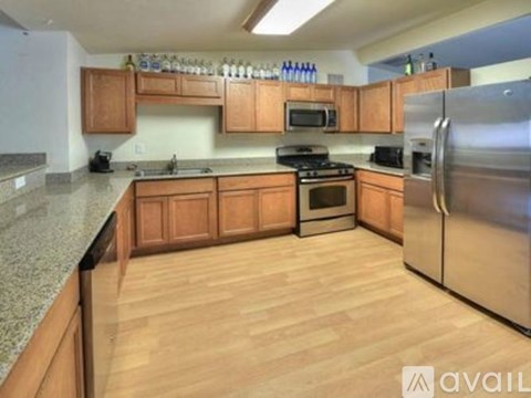 A kitchen with wooden cabinets and stainless steel appliances.