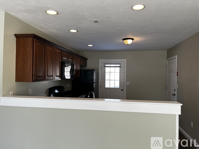 A kitchen with brown cabinets and a white countertop.