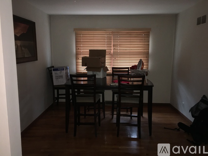 A dining room with a table and chairs.