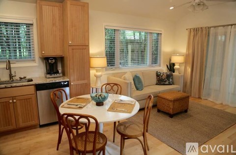 A kitchen with a table and chairs in the middle of the room.