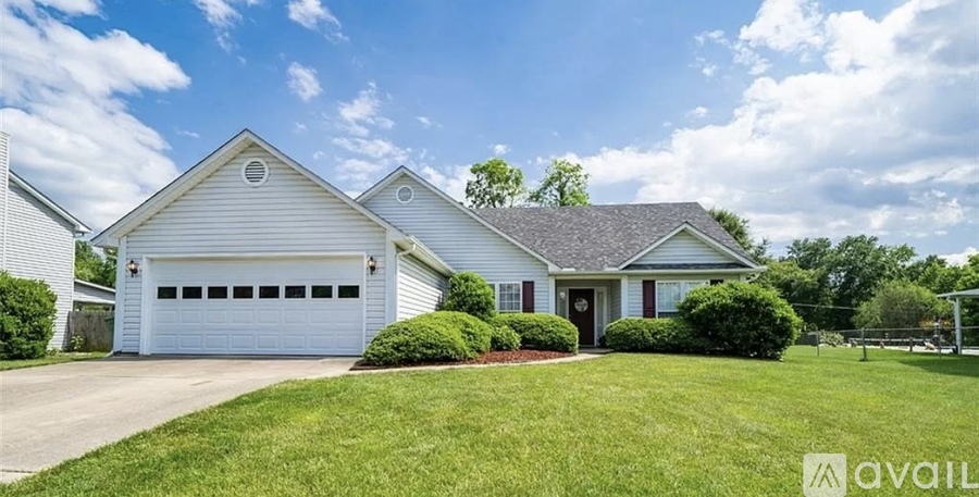 A house with a white garage door is for sale.