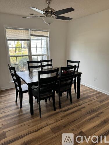A dining room with a table and chairs.