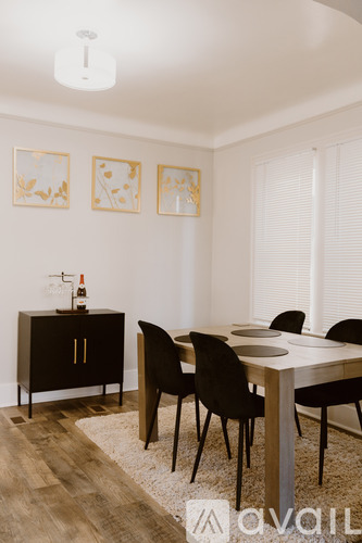 A dining room with a wooden table and chairs.