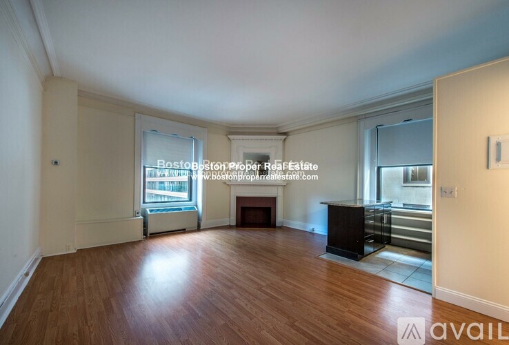 A spacious living room with hardwood floors and a fireplace.