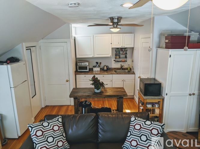 A living room with a couch and a television.
