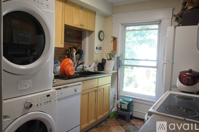A kitchen with a washer and dryer stacked on top of each other.