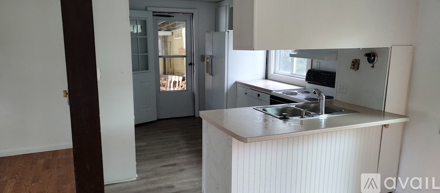 A kitchen with a sink and a stove top oven.
