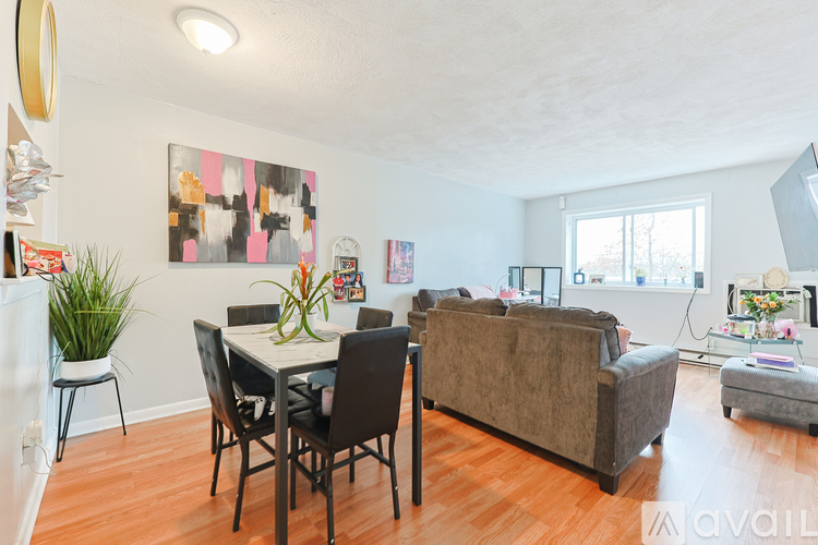A living room with a dining table and chairs.
