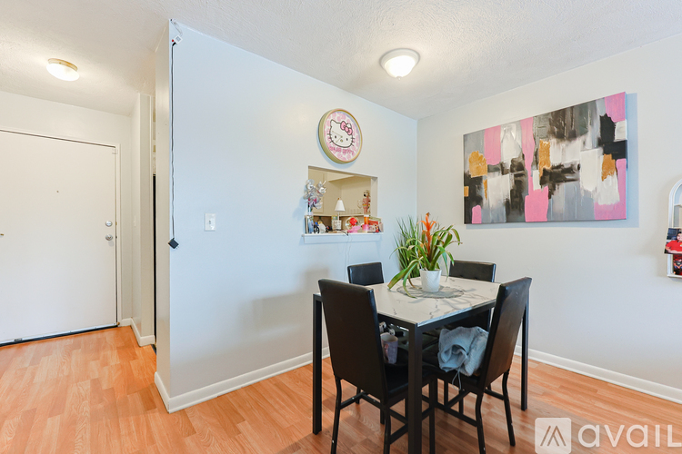 A dining room with a table set for four.