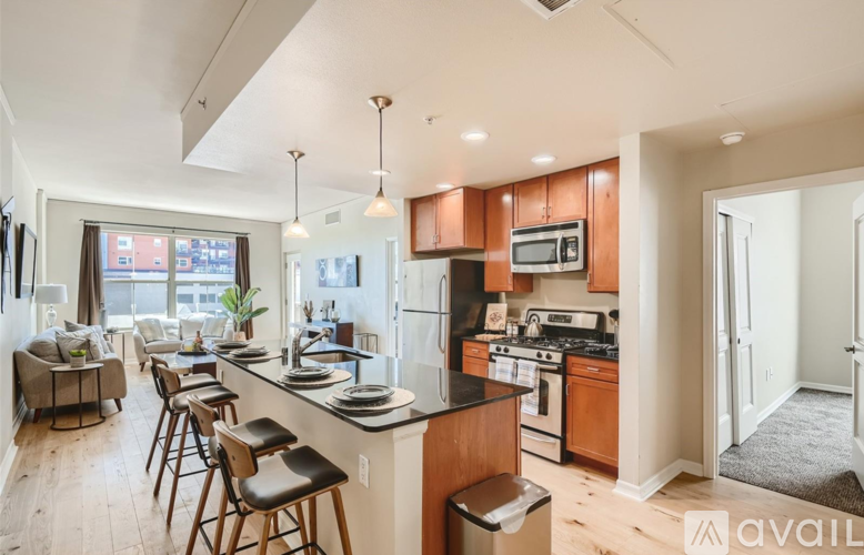A kitchen with wooden cabinets and a black countertop.