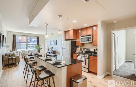 A kitchen with wooden cabinets and a black countertop.