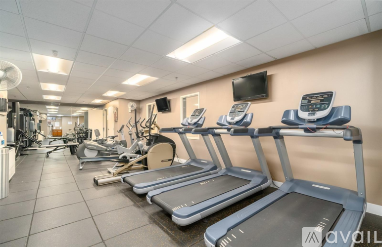 A gym with treadmills and other exercise equipment.