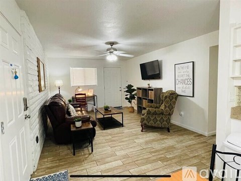 A living room with a brown chair and a green chair.
