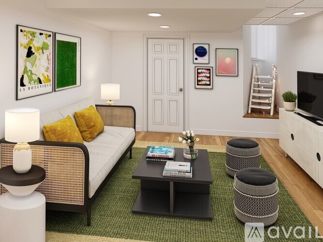 A living room with a sofa, a coffee table, and a TV.