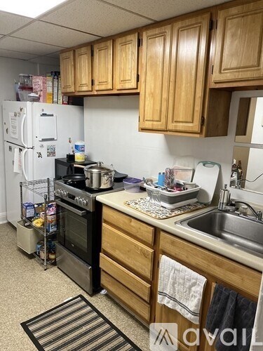 A kitchen with wooden cabinets and a white refrigerator.
