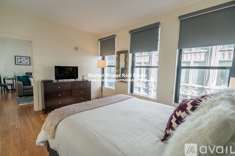 A bedroom with a large bed and a flat screen TV.