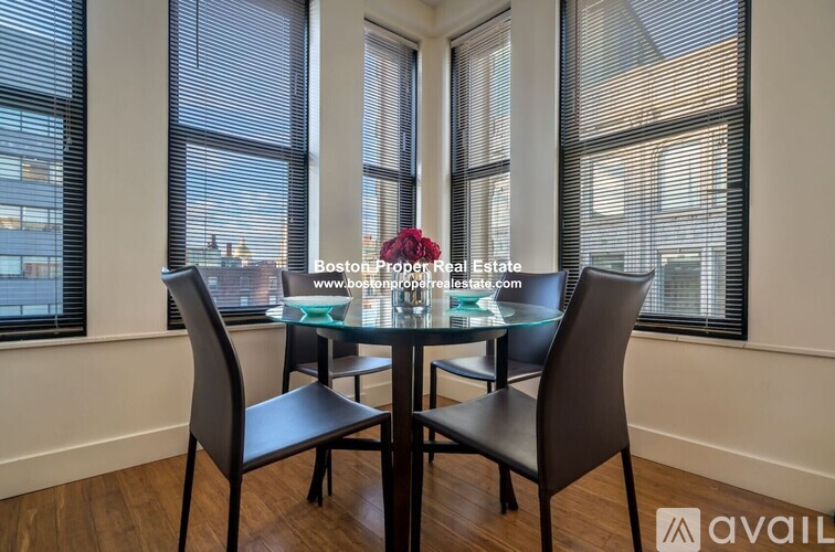 A dining room with a glass table and chairs.