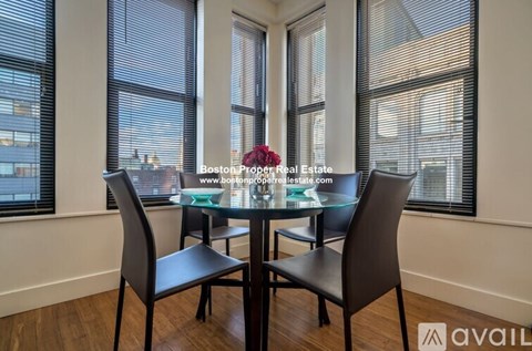 A dining room with a glass table and chairs.