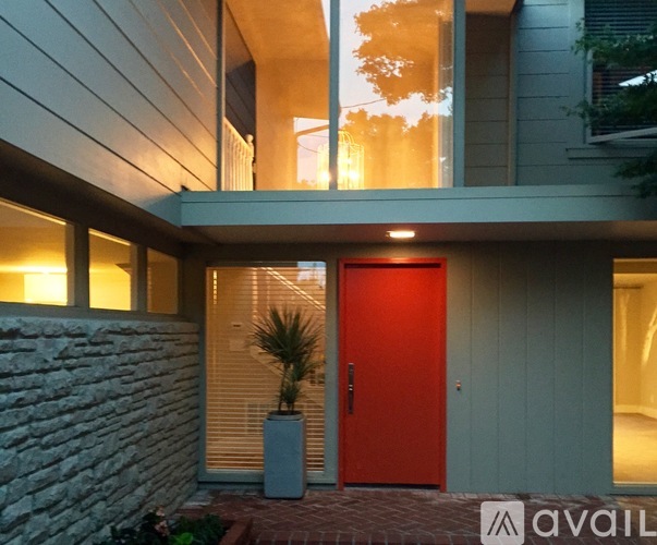 A red door is the focal point of this modern house entrance.