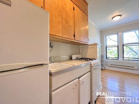 A kitchen with a white fridge, white dishwasher and white stove.