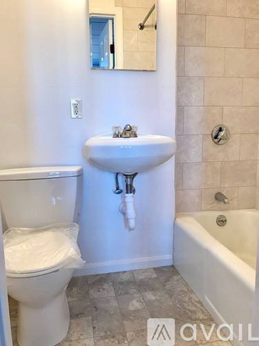 A white toilet is next to a sink in a bathroom.