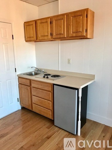 A kitchen with wooden cabinets and a white countertop.
