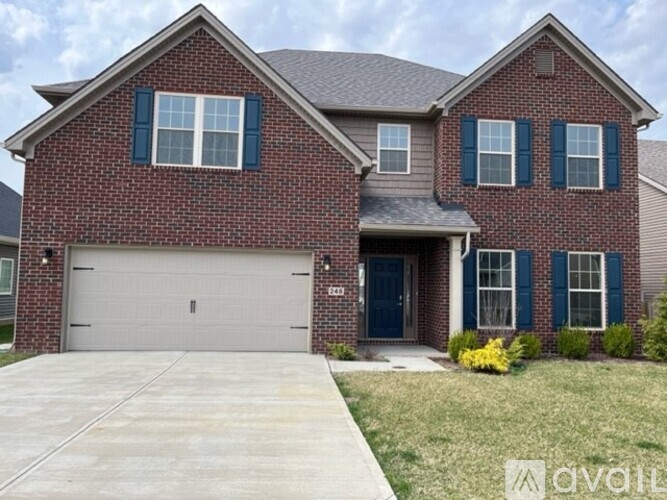 A brick house with a garage and a blue door.