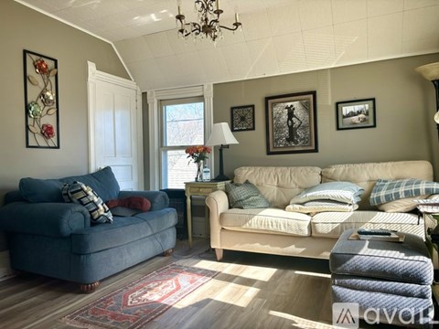A living room with a blue couch and a white couch.