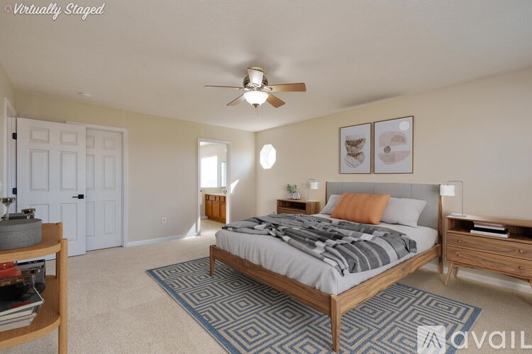 A bedroom with a bed, dresser, and ceiling fan.