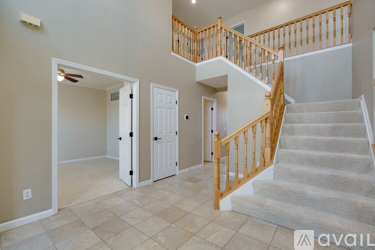 A spacious room with a staircase leading to the upper floor.
